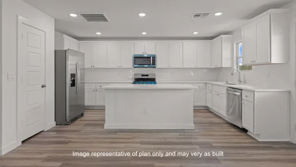 a kitchen with cabinets and stainless steel appliances