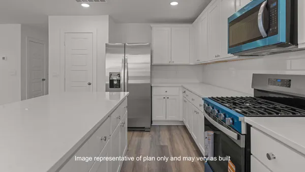 a kitchen with granite countertop a stove top oven and sink