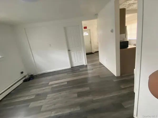 a view of a room with wooden floor