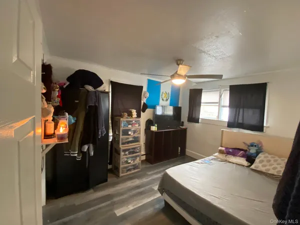 a bedroom with a bed and a television