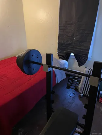 a bedroom with a bed next to a window