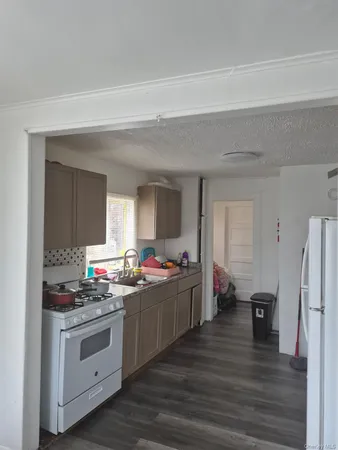 a kitchen with a stove and white cabinets