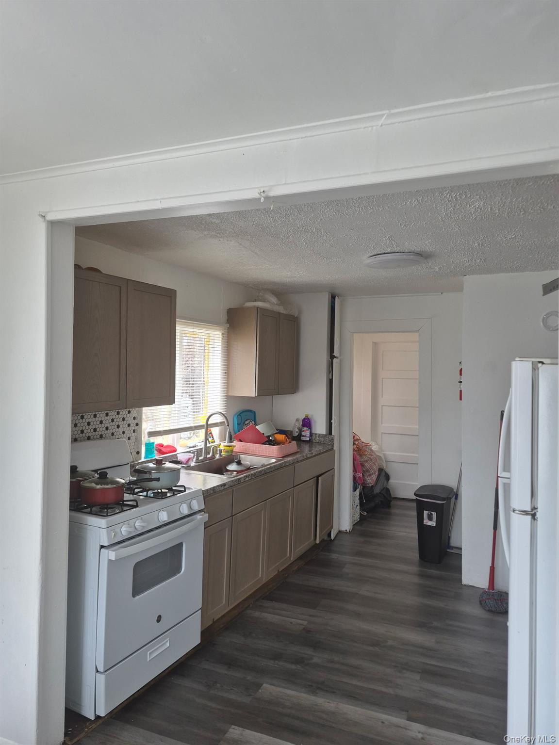 85 Grove Street Newburgh, NY 12550 - Photo 6 of 14 a kitchen with a stove and white cabinets