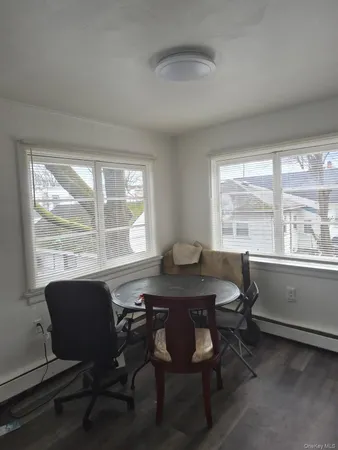 a view of a dining room with a table and chairs