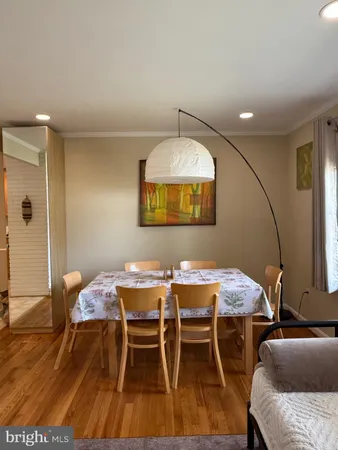 a dining room with furniture and wooden floor