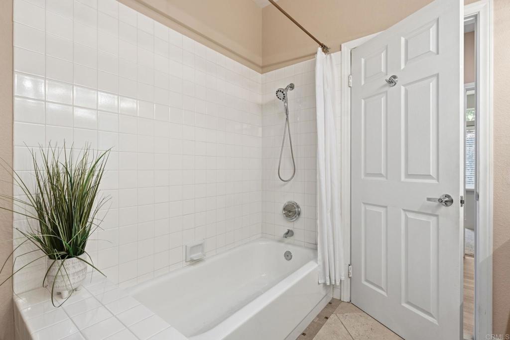 3602 Tulare Court Oceanside, CA 92056 - Photo 27 of 35 a bathroom with a shower a sink a window and a glass door shower