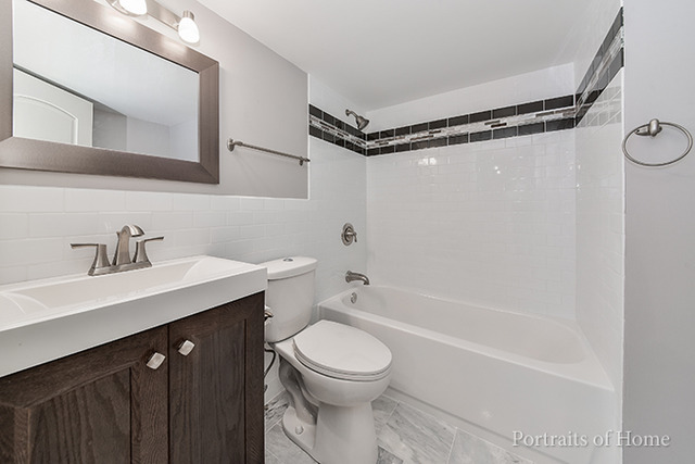 304 Bedford Road Bolingbrook, IL 60440 - Photo 21 of 25 a bathroom with a sink a toilet and a mirror
