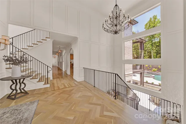 a view of entryway and hall with wooden floor
