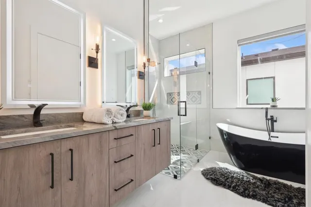 a spacious bathroom with a double vanity sink and mirror