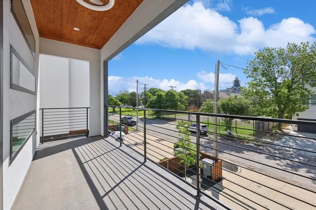 a view of a balcony with wooden floor