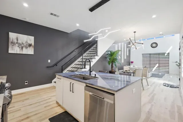 a kitchen with sink and mirror