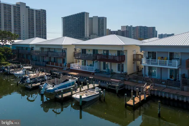 a couple of table and chairs under an umbrella