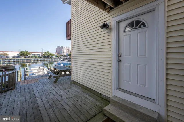 a view of a balcony with chairs and wooden floor