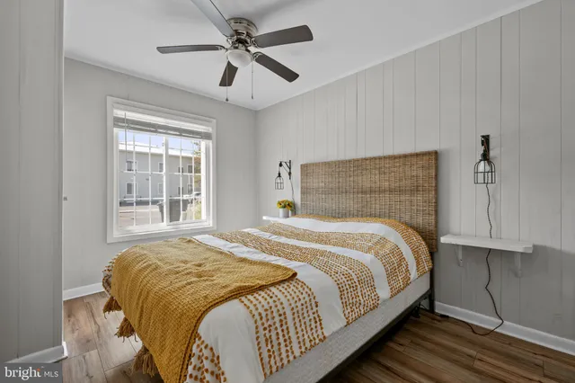 a bedroom with a large bed and a ceiling fan