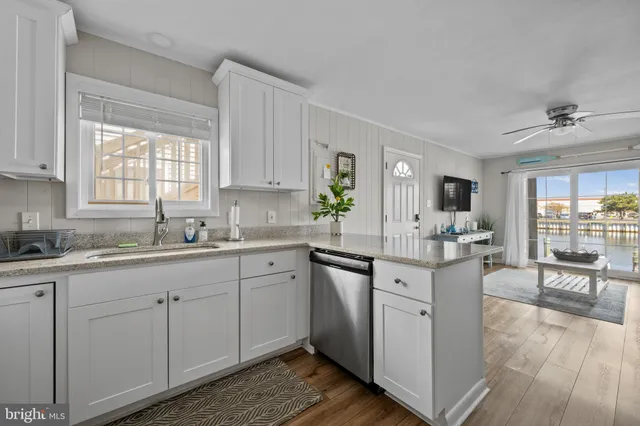a kitchen with sink cabinets and wooden floor