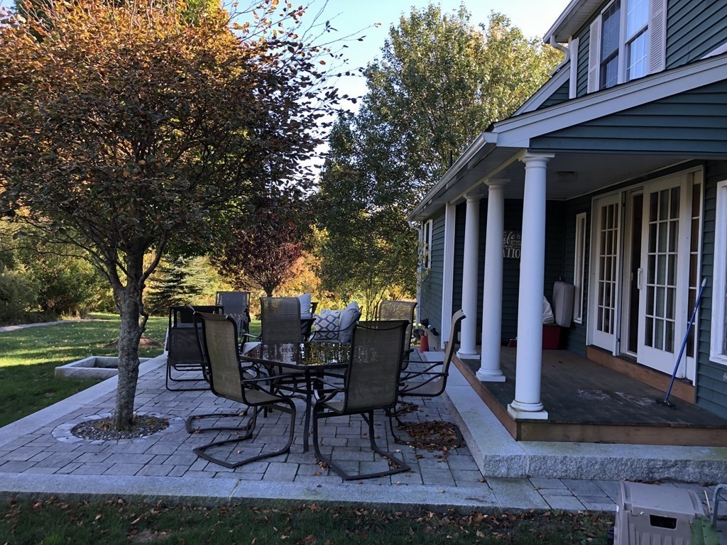 6 Nick Alan Circle Rutland, MA 01543 - Photo 31 of 39 a view of a backyard with table and chairs potted plants and large tree