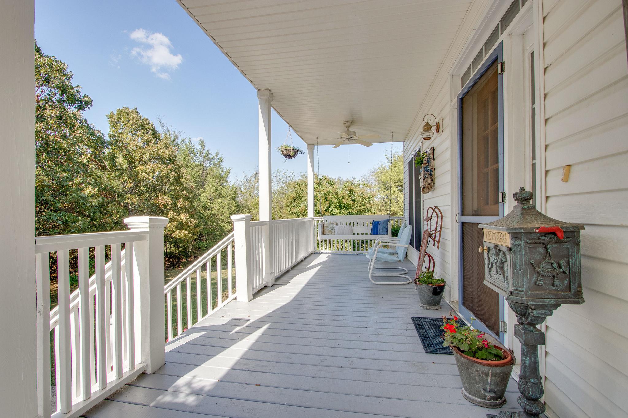 382 Lohman Road Mount Juliet, TN 37122 - Photo 3 of 30 a view of a balcony with chairs and wooden fence