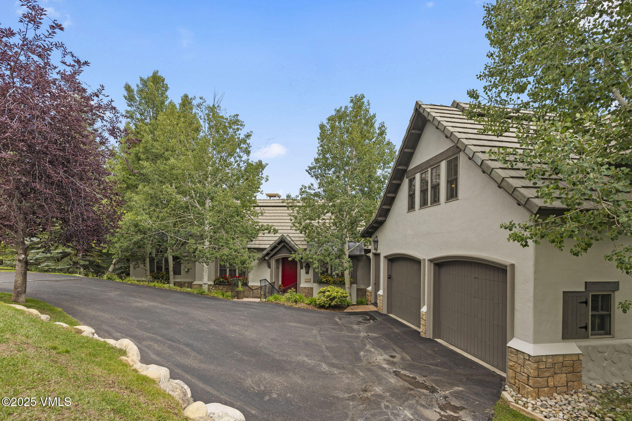 94 Eagles Glen Road Edwards, CO 81632 - Photo 41 of 43 a view of a white house with a small yard and large trees