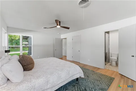 a bedroom with a large bed and a window