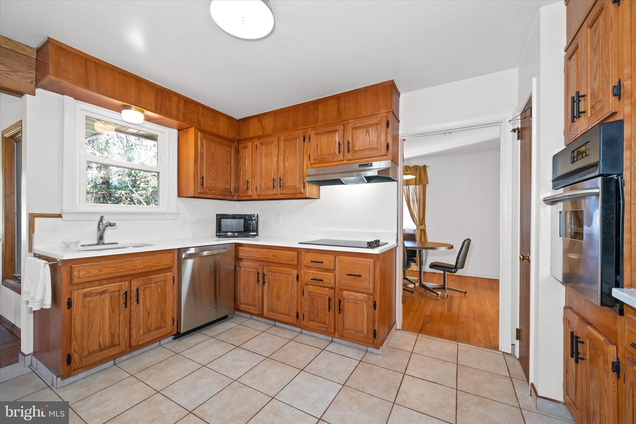 213 Valley Lane Hockessin, DE 19707 - Photo 11 of 27 a kitchen with stainless steel appliances granite countertop a sink and cabinets