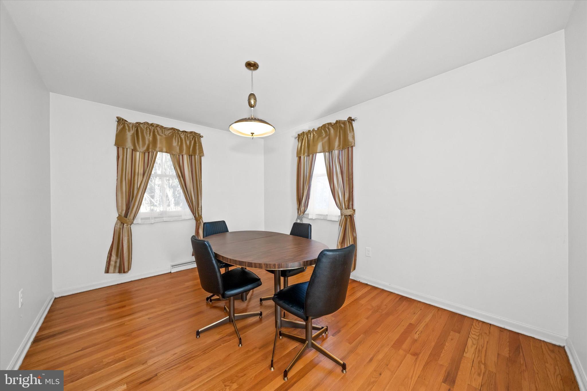 213 Valley Lane Hockessin, DE 19707 - Photo 12 of 27 a view of a dining room with furniture and wooden floor