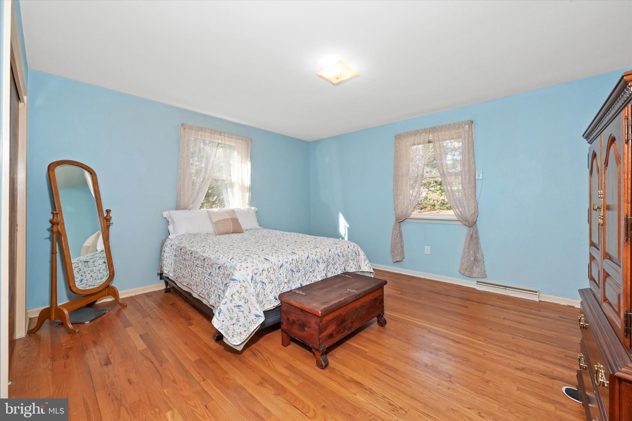213 Valley Lane Hockessin, DE 19707 - Photo 15 of 27 a spacious bedroom with a bed and a dresser next to a window