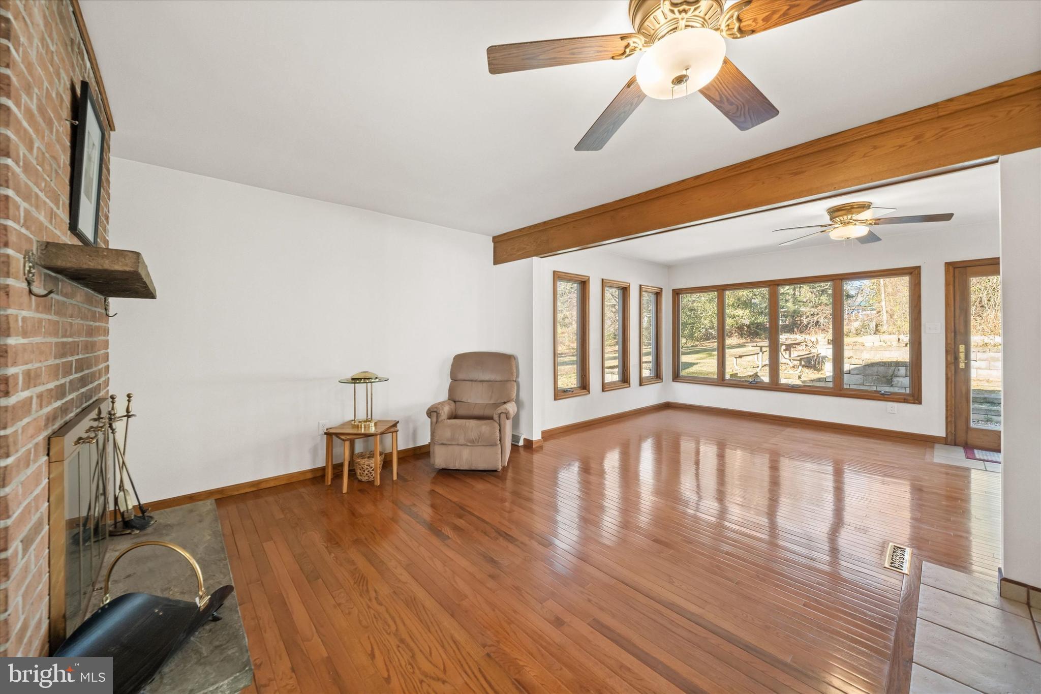 213 Valley Lane Hockessin, DE 19707 - Photo 4 of 27 a view of an empty room with wooden floor and a window