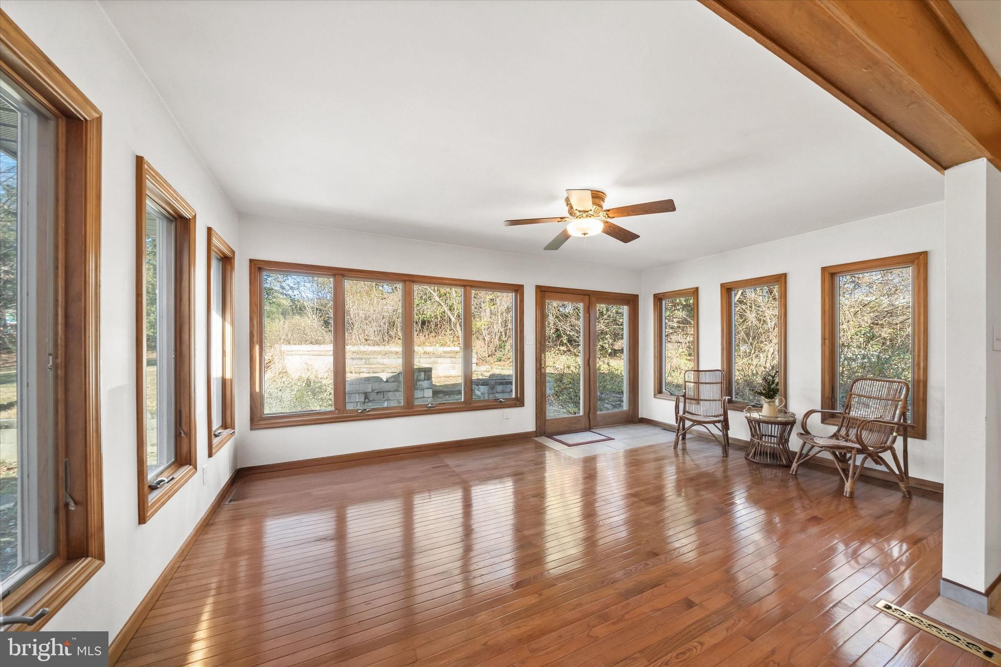 213 Valley Lane Hockessin, DE 19707 - Photo 5 of 27 a view of an empty room with wooden floor and a window