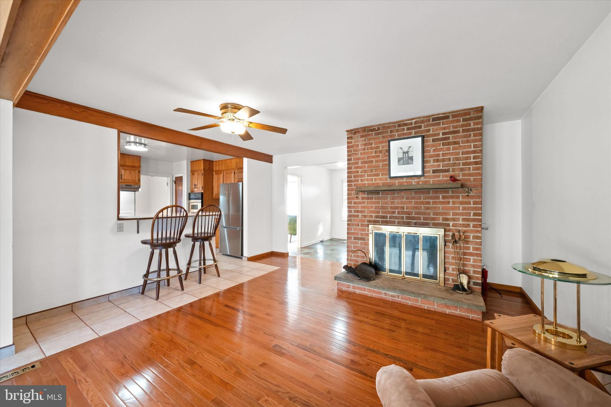 213 Valley Lane Hockessin, DE 19707 - Photo 6 of 27 a living room with furniture and a floor to ceiling window