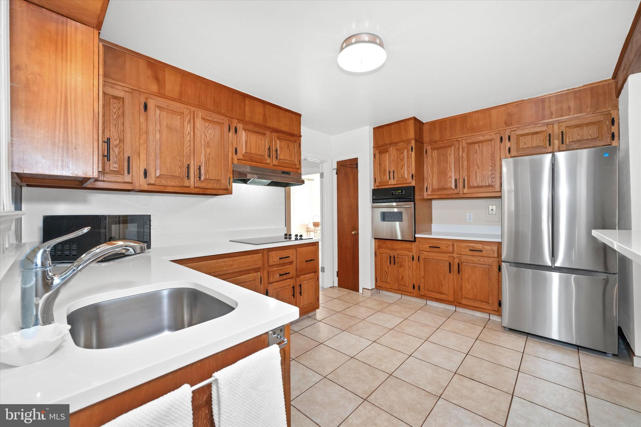 213 Valley Lane Hockessin, DE 19707 - Photo 10 of 27 a kitchen with stainless steel appliances granite countertop a refrigerator sink and cabinets