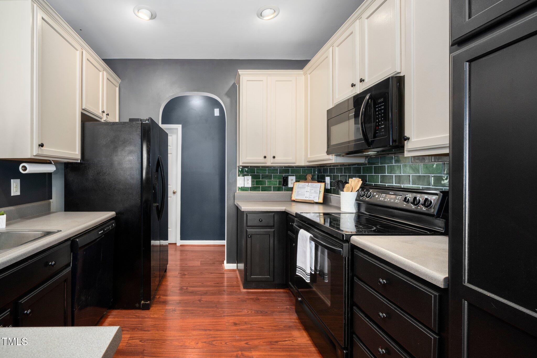 8300 Neuse Hunter Drive Raleigh, NC 27616 - Photo 11 of 32 a kitchen with stainless steel appliances granite countertop a refrigerator stove and sink