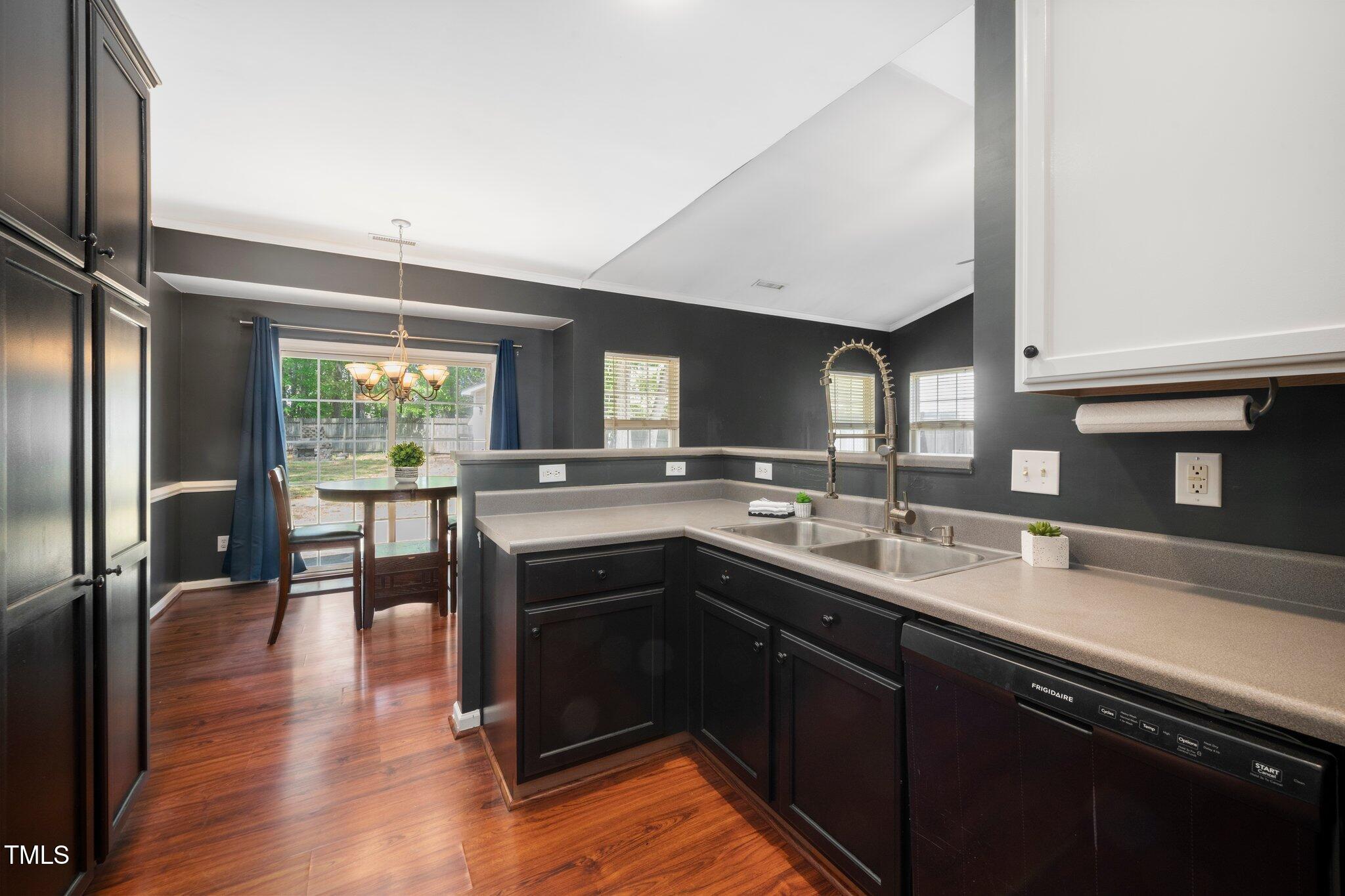 8300 Neuse Hunter Drive Raleigh, NC 27616 - Photo 13 of 32 a kitchen with stainless steel appliances granite countertop a sink a stove and a refrigerator