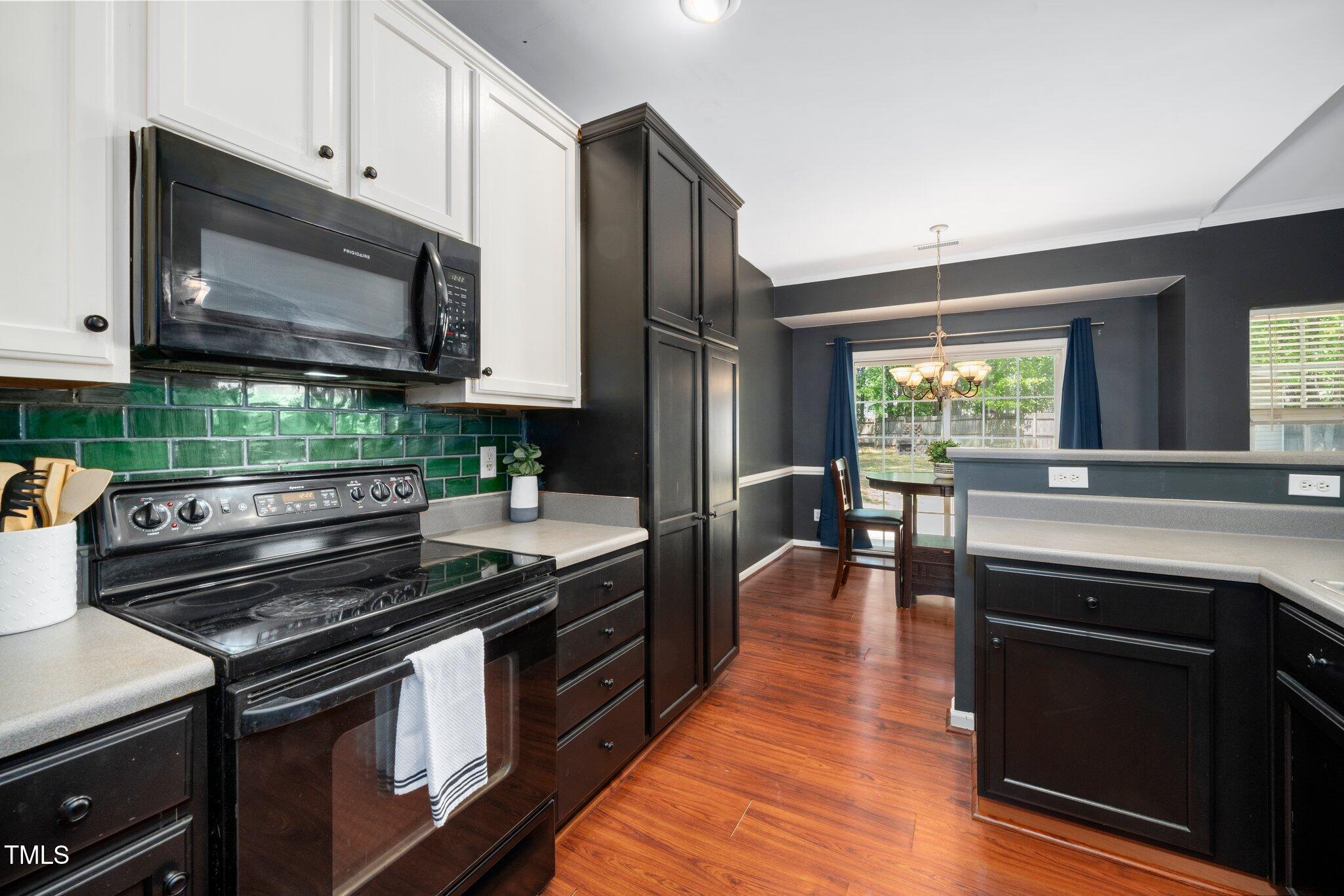 8300 Neuse Hunter Drive Raleigh, NC 27616 - Photo 14 of 32 a kitchen with a stove and a microwave