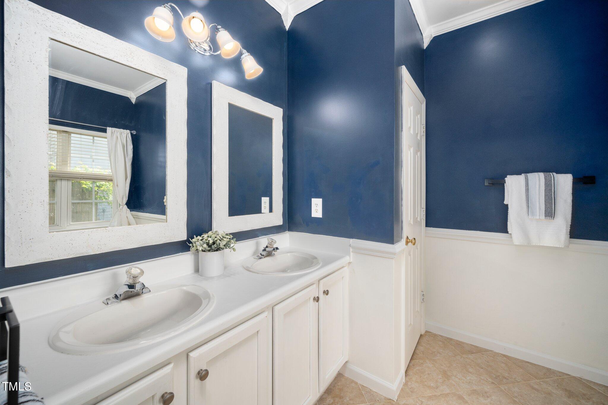8300 Neuse Hunter Drive Raleigh, NC 27616 - Photo 17 of 32 a bathroom with a sink and a mirror