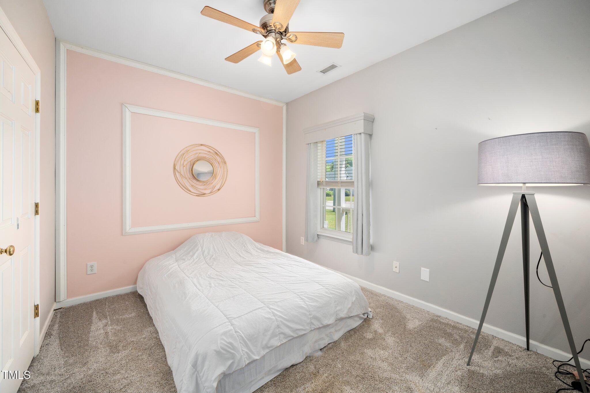 8300 Neuse Hunter Drive Raleigh, NC 27616 - Photo 19 of 32 a bedroom with a bed and a flat tv screen