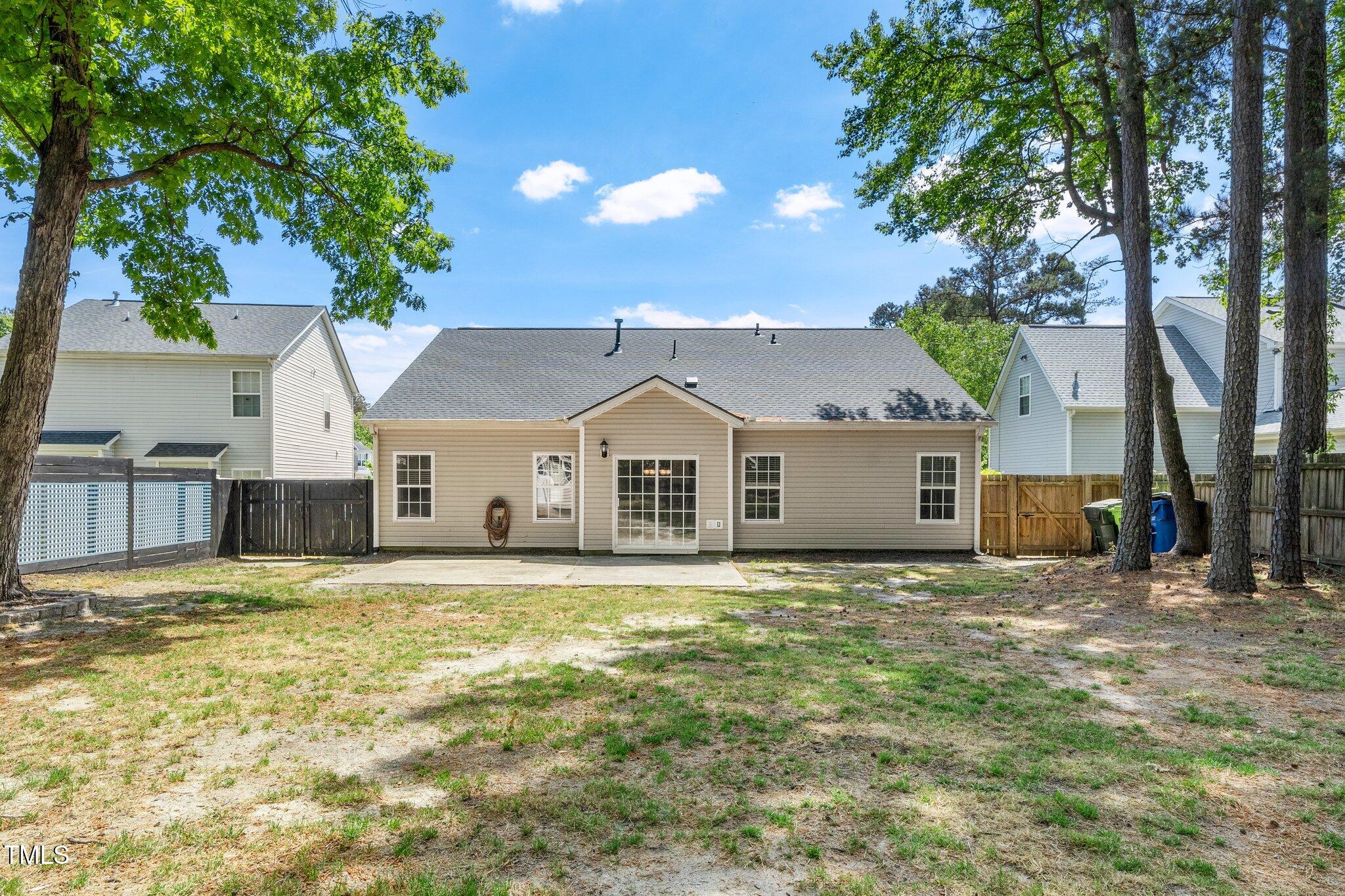 8300 Neuse Hunter Drive Raleigh, NC 27616 - Photo 29 of 32 a house that has a big yard with large trees and wooden fence