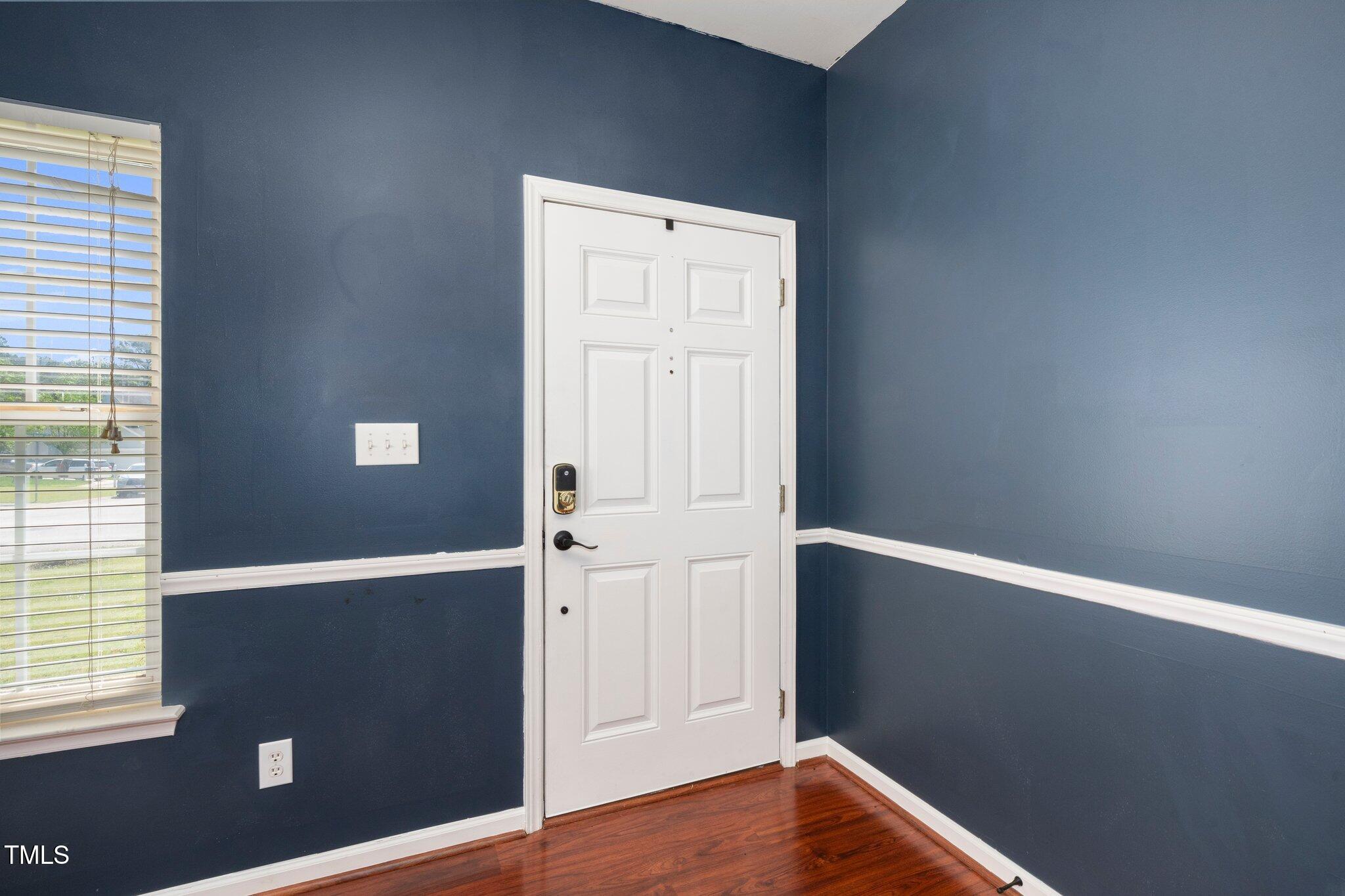 8300 Neuse Hunter Drive Raleigh, NC 27616 - Photo 5 of 32 an empty room with wooden floor and windows