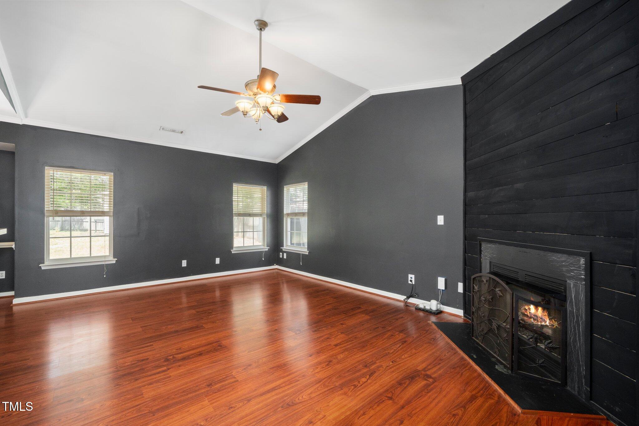 8300 Neuse Hunter Drive Raleigh, NC 27616 - Photo 6 of 32 a view of an empty room with window and wooden floor