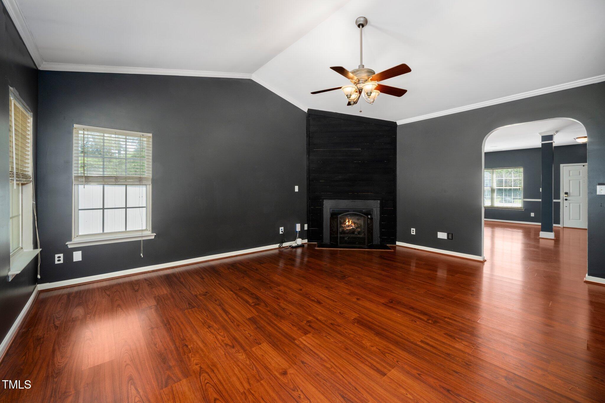 8300 Neuse Hunter Drive Raleigh, NC 27616 - Photo 8 of 32 an empty room with wooden floor chandelier fan and windows