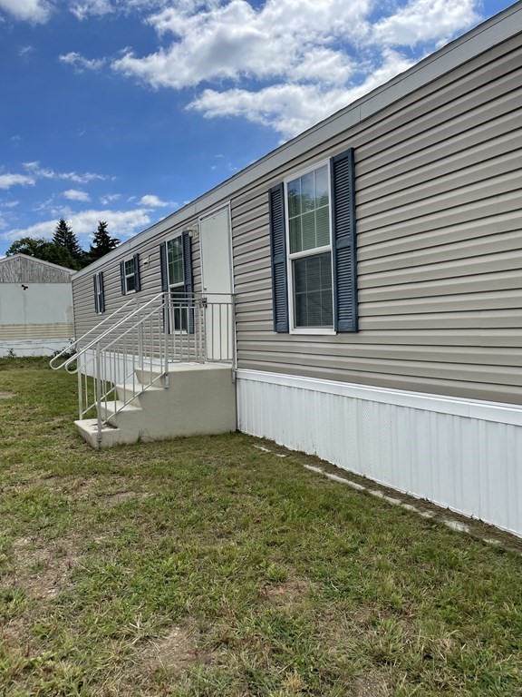 268 Palmer Road, Unit 23 Monson, MA 01057 - Photo 1 of 18 a view of a house with a yard
