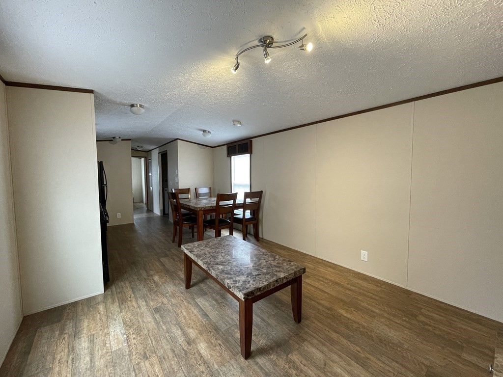 268 Palmer Road, Unit 23 Monson, MA 01057 - Photo 2 of 18 a living room with furniture and wooden floor