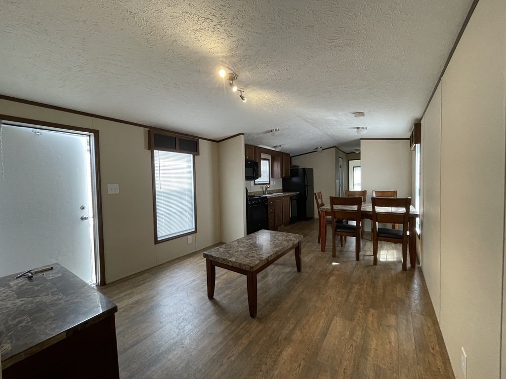 268 Palmer Road, Unit 23 Monson, MA 01057 - Photo 3 of 18 a living room with furniture and a wooden floor