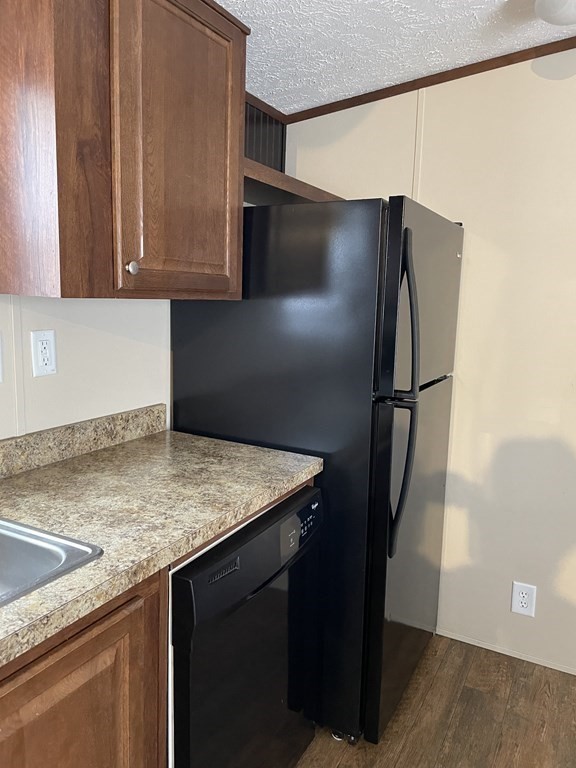 268 Palmer Road, Unit 23 Monson, MA 01057 - Photo 7 of 18 a kitchen with stainless steel appliances granite countertop a refrigerator and a sink