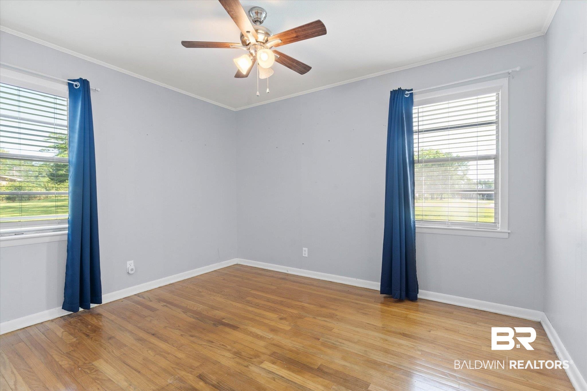 427 Upper Ferry Road Leroy, AL 36548 - Photo 9 of 37 Spare room with plenty of natural light, a ceiling fan, light wood-style floors, ornamental molding, and baseboards