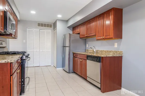 a kitchen with granite countertop cabinets and window