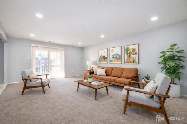 a kitchen with stainless steel appliances granite countertop a stove top oven a sink dishwasher and a refrigerator with wooden cabinets