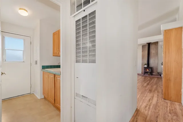an empty room with windows and ceiling fan