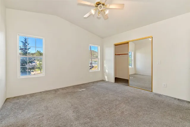 a view of a livingroom with furniture and chandelier fan