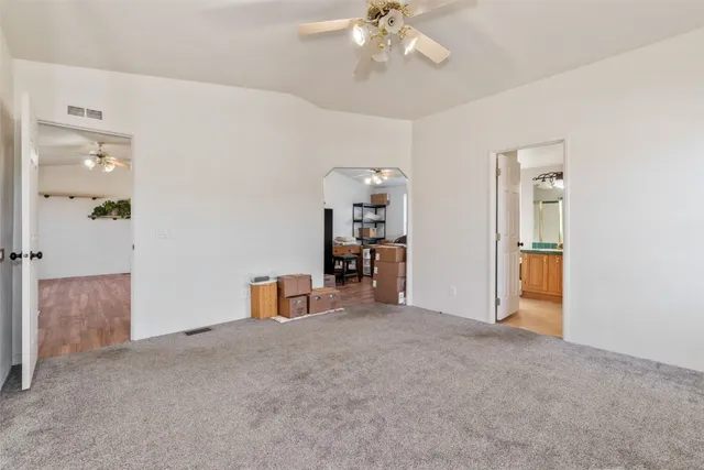 a spacious bathroom with a granite countertop sink and a large mirror