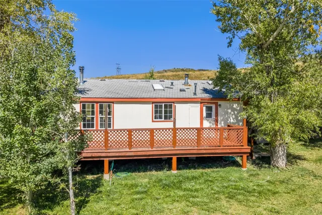 a view of a house with a yard and sitting area
